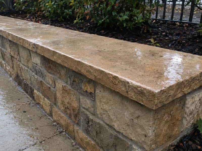 Stone wall caps protecting a low masonry wall from rain in Fort Worth, Texas.